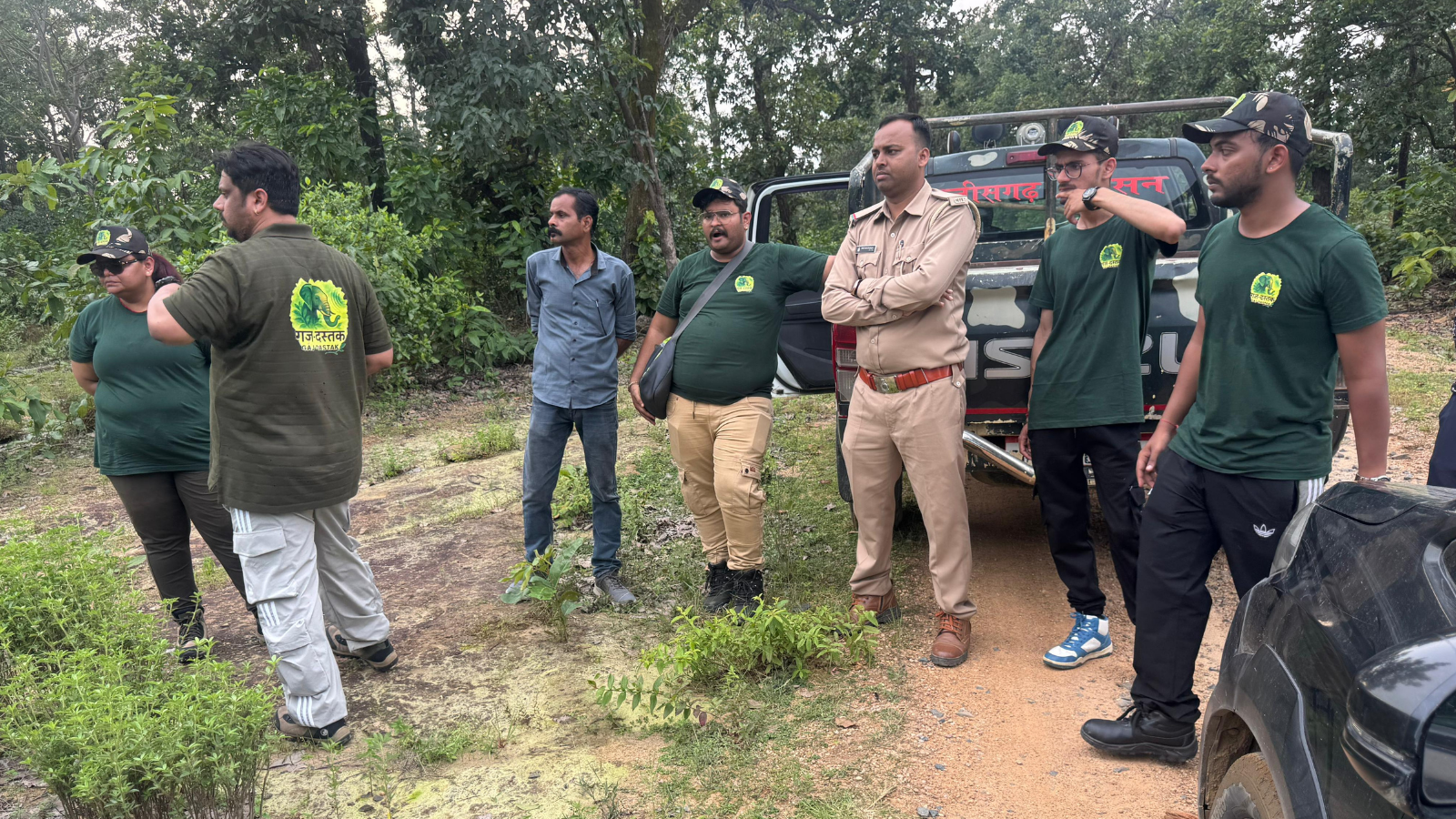 Team in discussion with forest officers at deployment site
